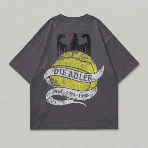 Grey t-shirt with yellow "DIE ADLER" text on a distressed ribbon over a black eagle graphic.