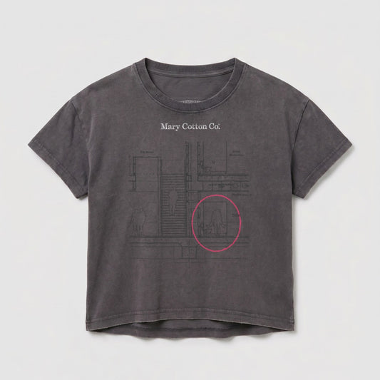 Gray t-shirt with schematic design and pink circle highlighting area.