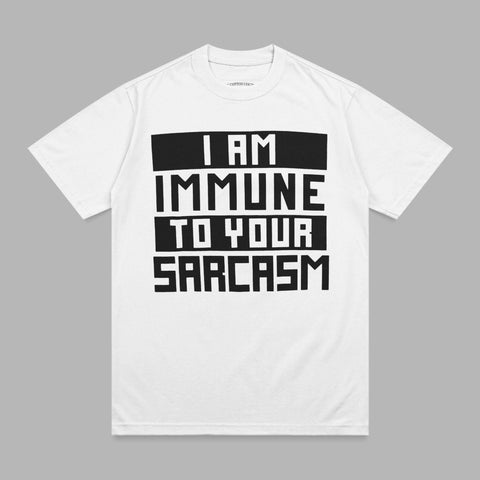 White t-shirt with black block text reading "I AM IMMUNE TO YOUR SARCASTIC".