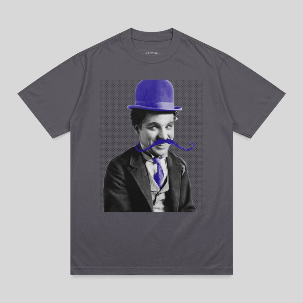 Charlie Chaplin wearing a blue bowler hat and blue tie with a prominent mustache.