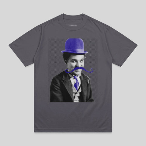 Charlie Chaplin wearing a blue bowler hat and blue tie with a prominent mustache.