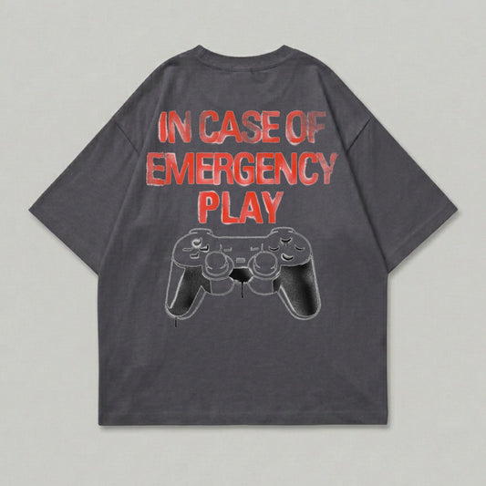 Dark grey t-shirt with "In Case of Emergency Play" and a video game controller graphic.