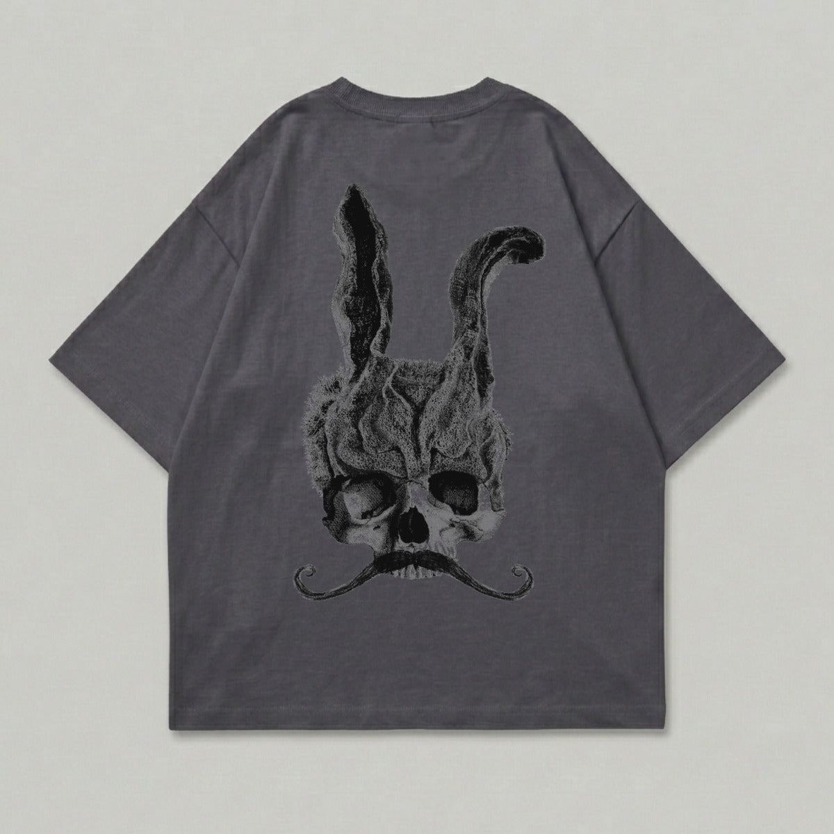 Dark grey t-shirt with a skull and rabbit ears graphic and mustache.