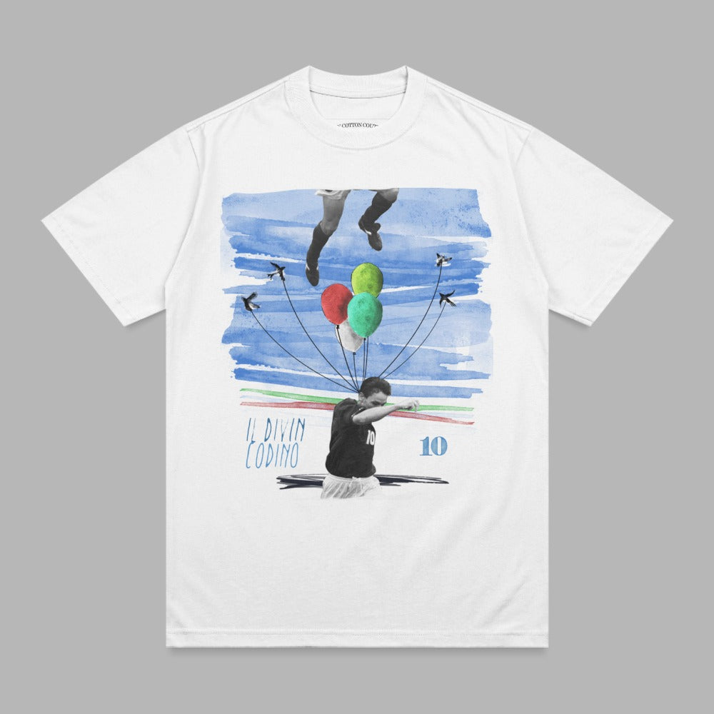White t-shirt with a graphic of a soccer player celebrating with balloons and the text "IL DIVIN CODINO".