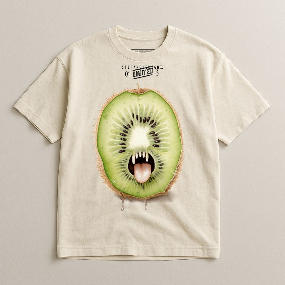 Kiwi fruit slice with fangs and green fur on a light cream t-shirt.
