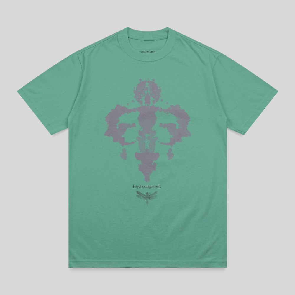 Green t-shirt with a Rorschach-style ink blot design and dragonfly.
