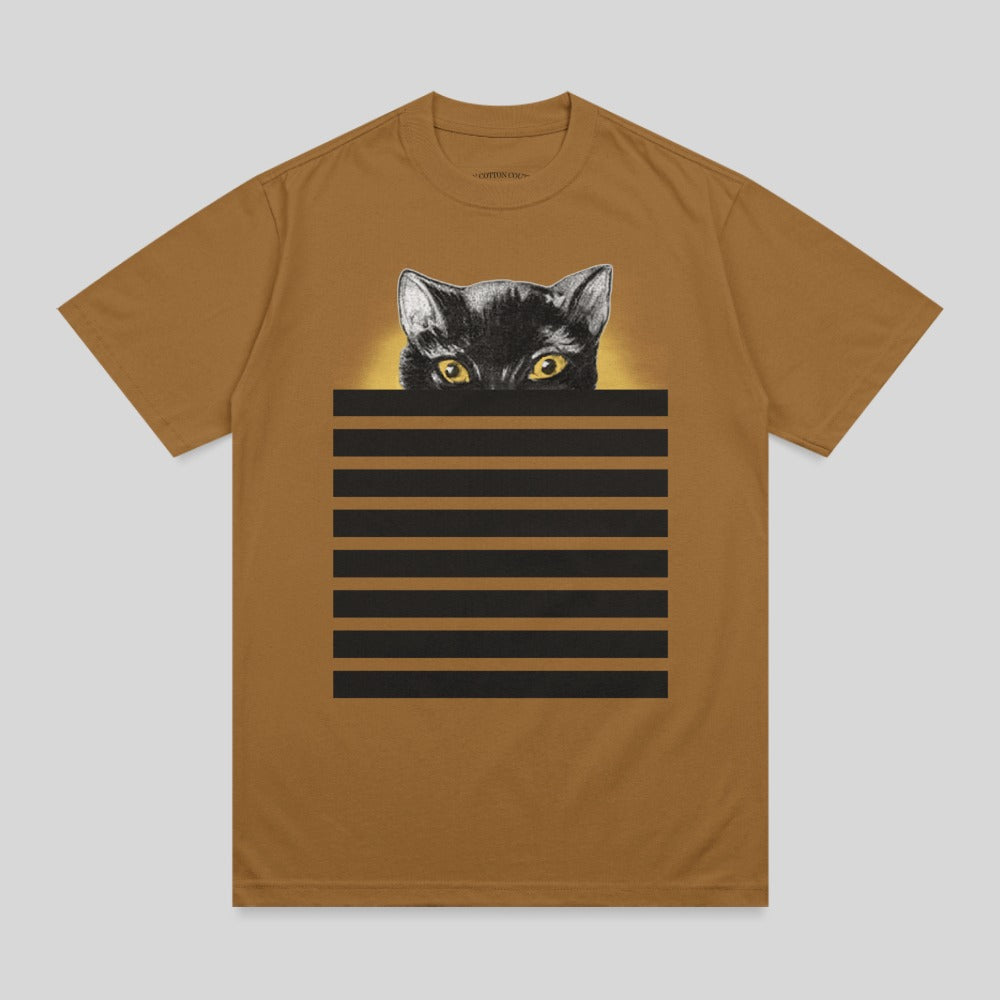 Black cat with yellow eyes peeking over horizontal black stripes on a brown t-shirt.