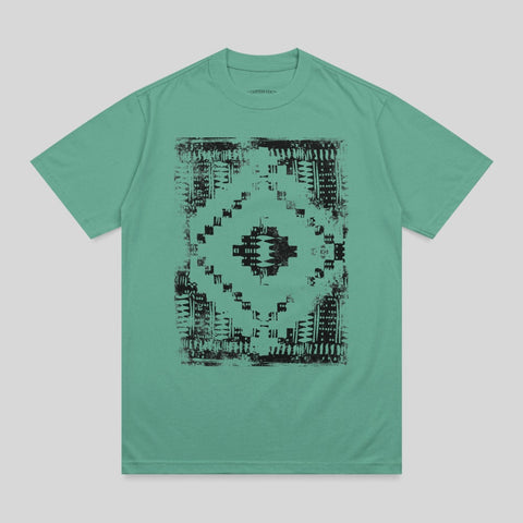 Teal t-shirt with black geometric tribal pattern on chest.