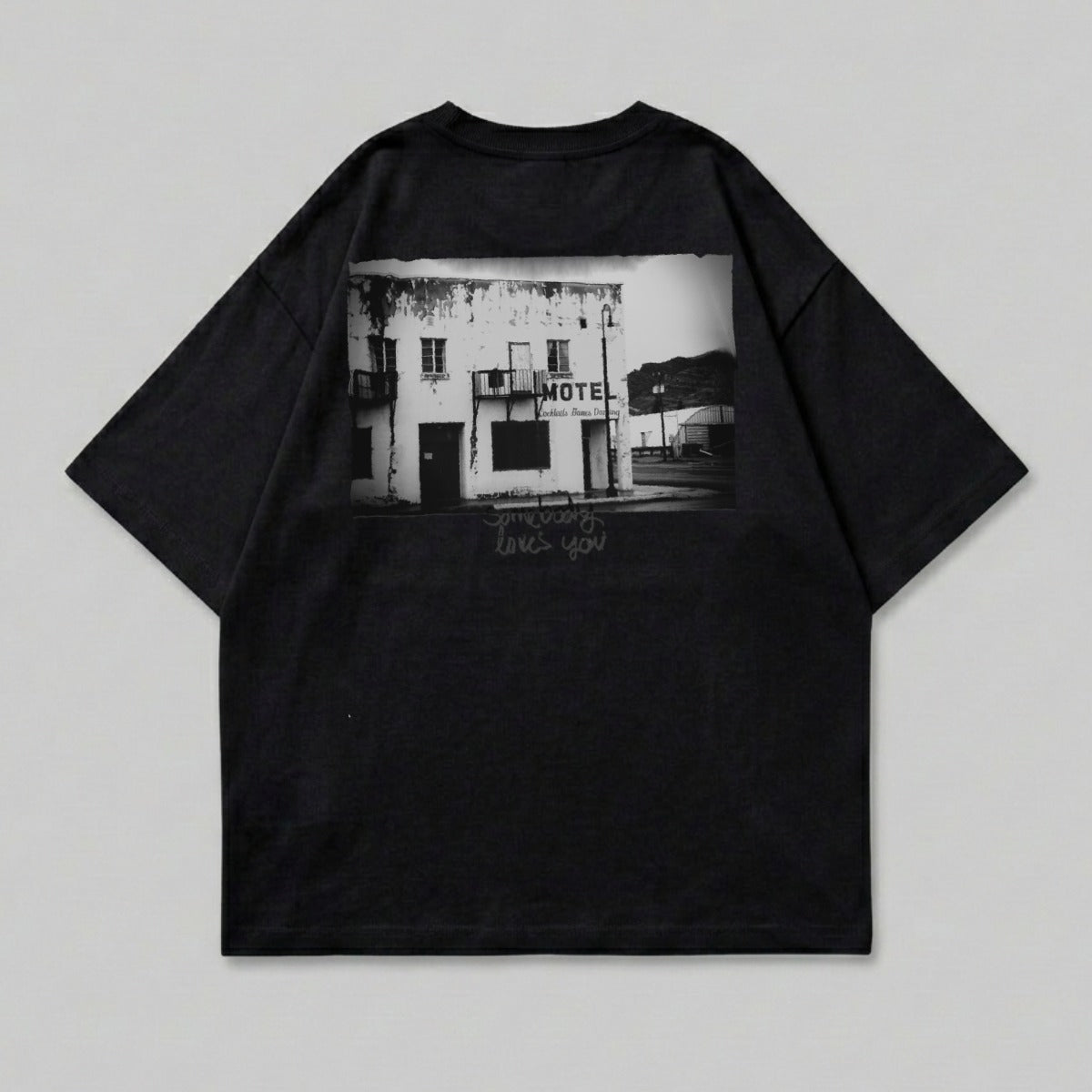 Black t-shirt with graphic of a rundown motel building.