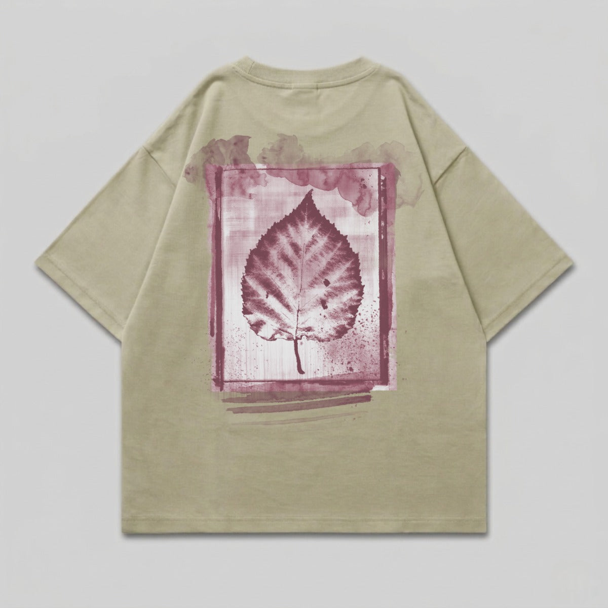 Tan t-shirt with a watercolor leaf print on the back.