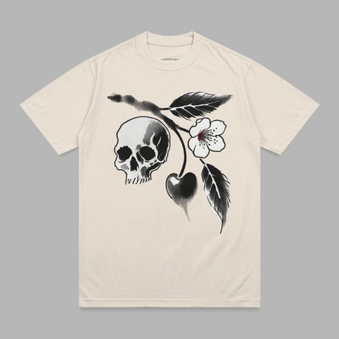 Cream t-shirt with a black and white skull and cherry blossom branch graphic.