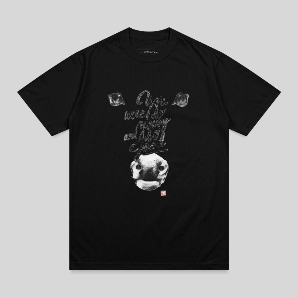 Black t-shirt with a stylized cow face graphic and text.
