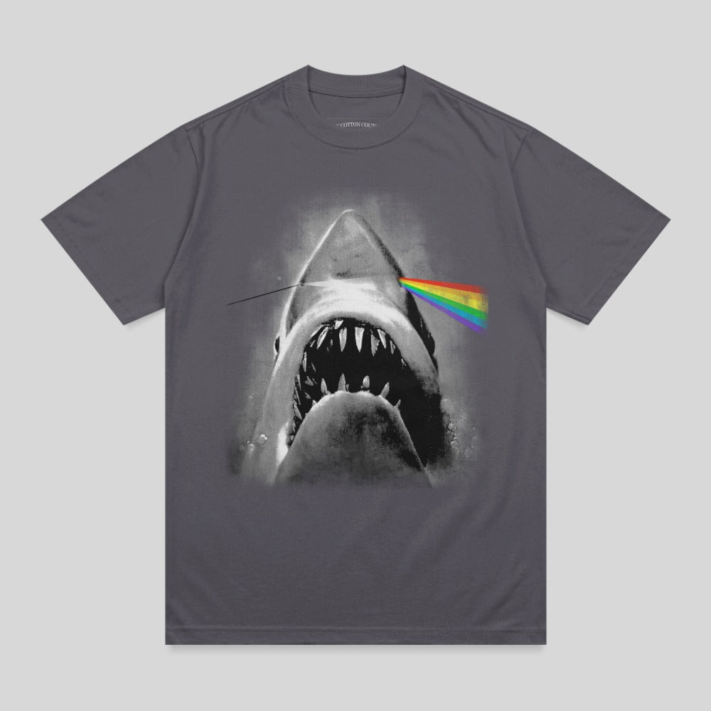 Shark jaws open with rainbow prism beam through eye on dark grey t-shirt.