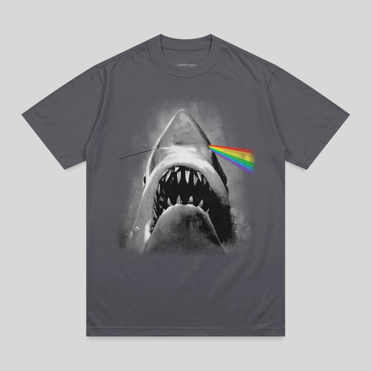 Shark jaws open with rainbow prism beam through eye on dark grey t-shirt.