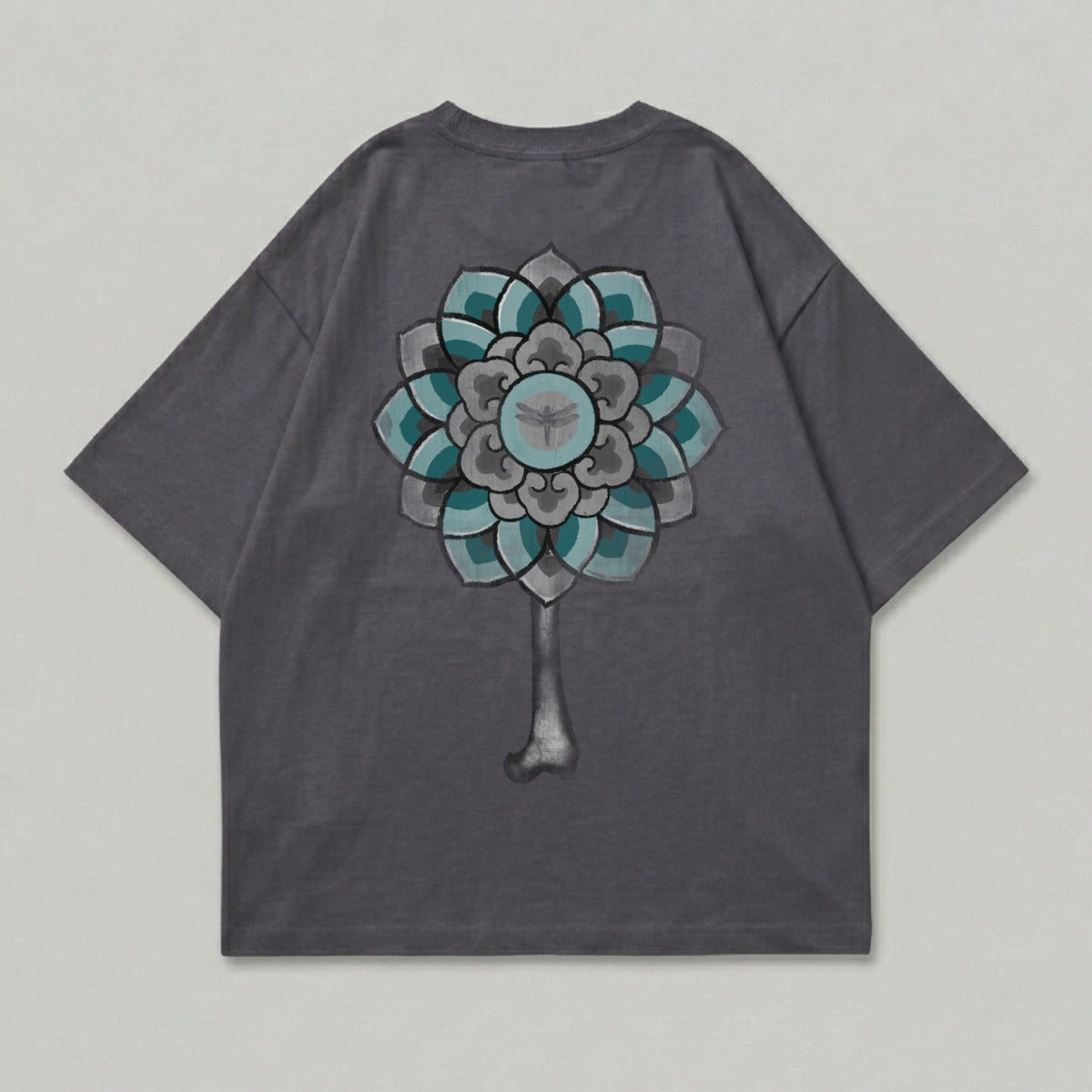 Dark grey t-shirt with a teal and grey floral design and insect on back.