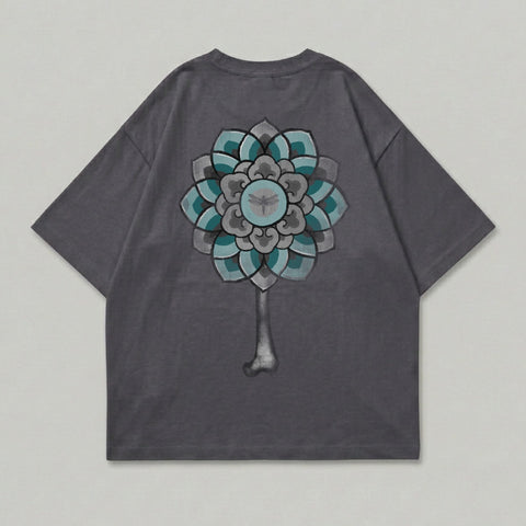 Dark grey t-shirt with a teal and grey floral design and insect on back.