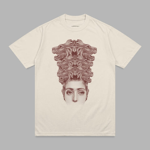 T-shirt with stylized human face topped by a cluster of lion heads.