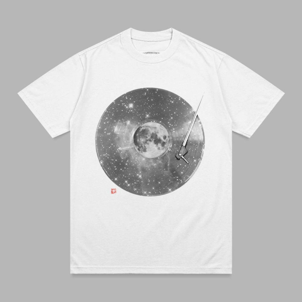 White t-shirt with a circular graphic of a vinyl record with stars and the moon.