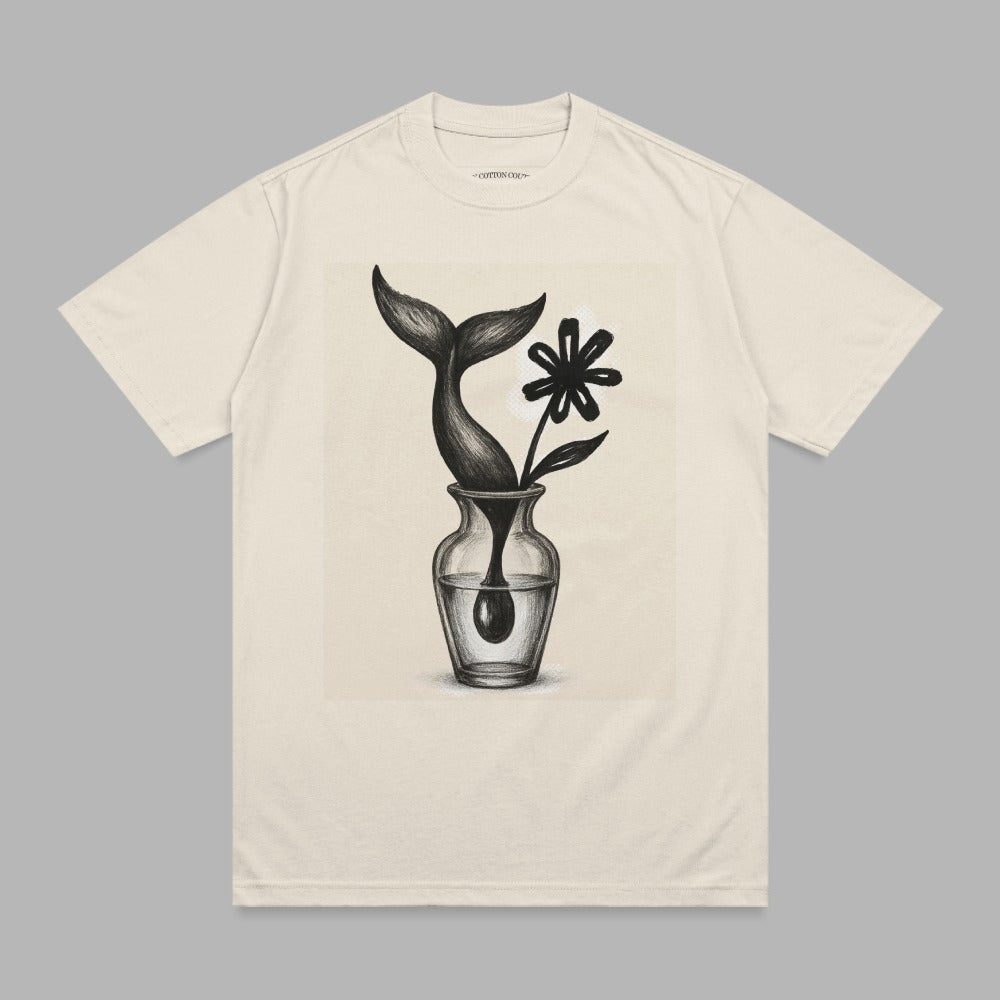 Cream t-shirt with a sketch of a whale tail and flower in a vase.