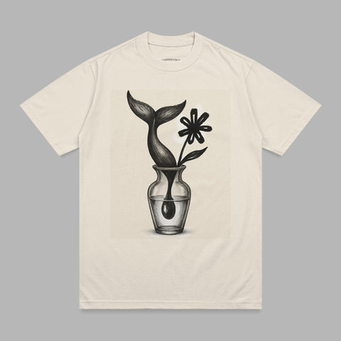 Cream t-shirt with a sketch of a whale tail and flower in a vase.