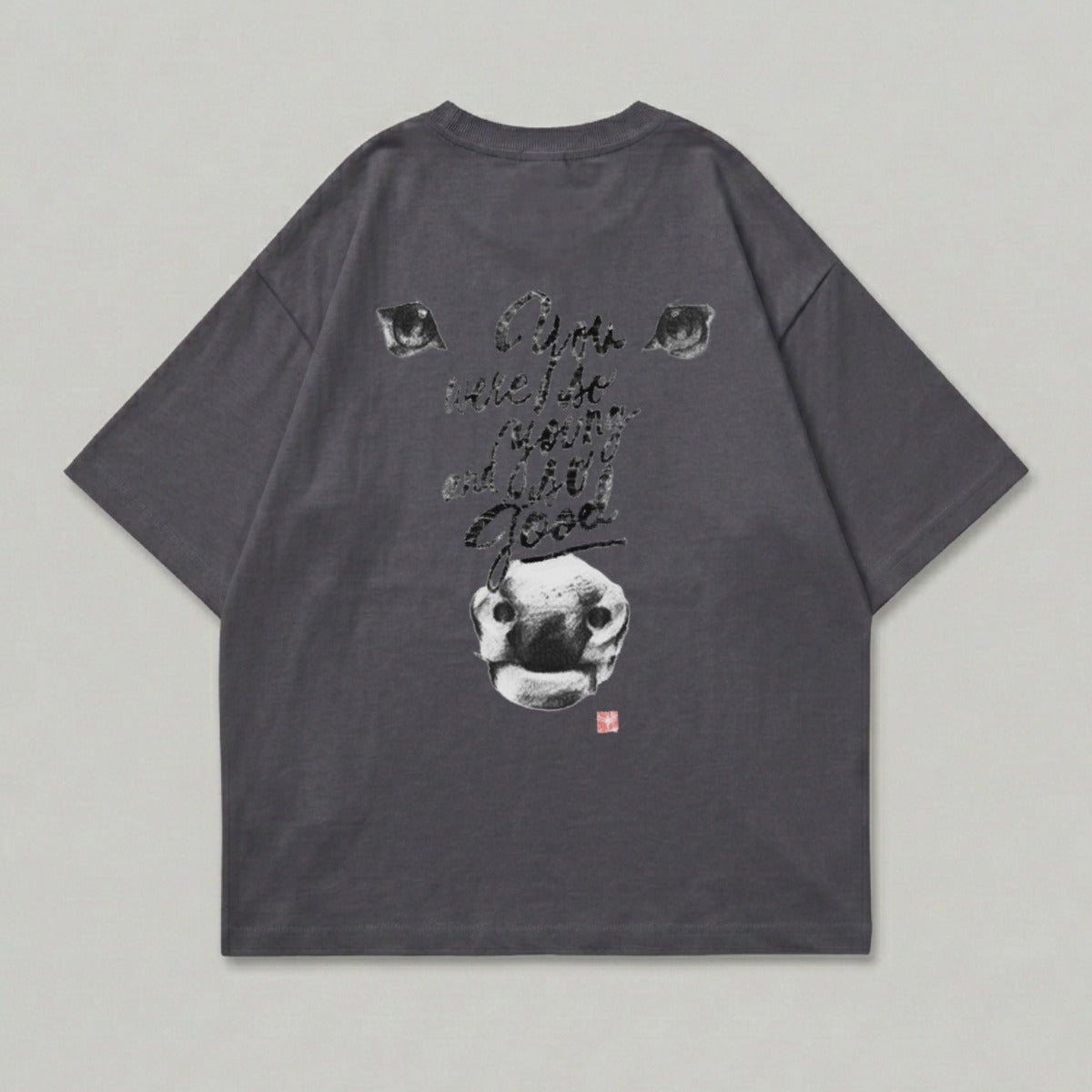 Dark cow eyes and nose with text on charcoal t-shirt.