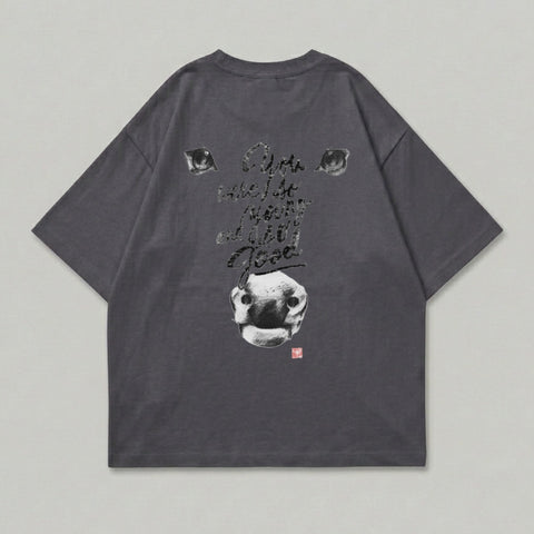 Dark cow eyes and nose with text on charcoal t-shirt.