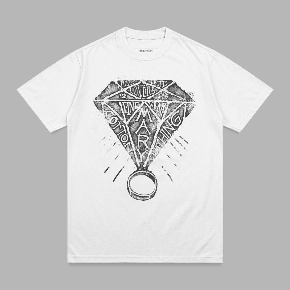 White t-shirt with black diamond graphic and ring, text "COTTON MARY" on shirt.