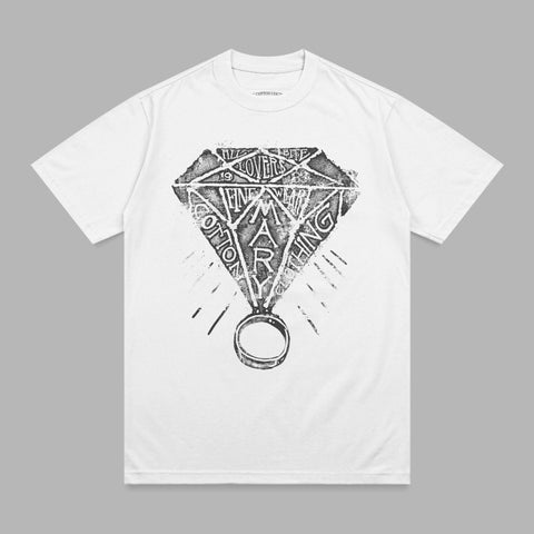 White t-shirt with black diamond graphic and ring, text "COTTON MARY" on shirt.