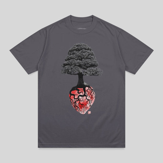 Graphic t-shirt featuring a dark tree rooted in a stylized anatomical heart.