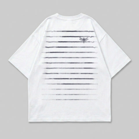 White t-shirt with horizontal gradient stripes and a small dragonfly graphic.