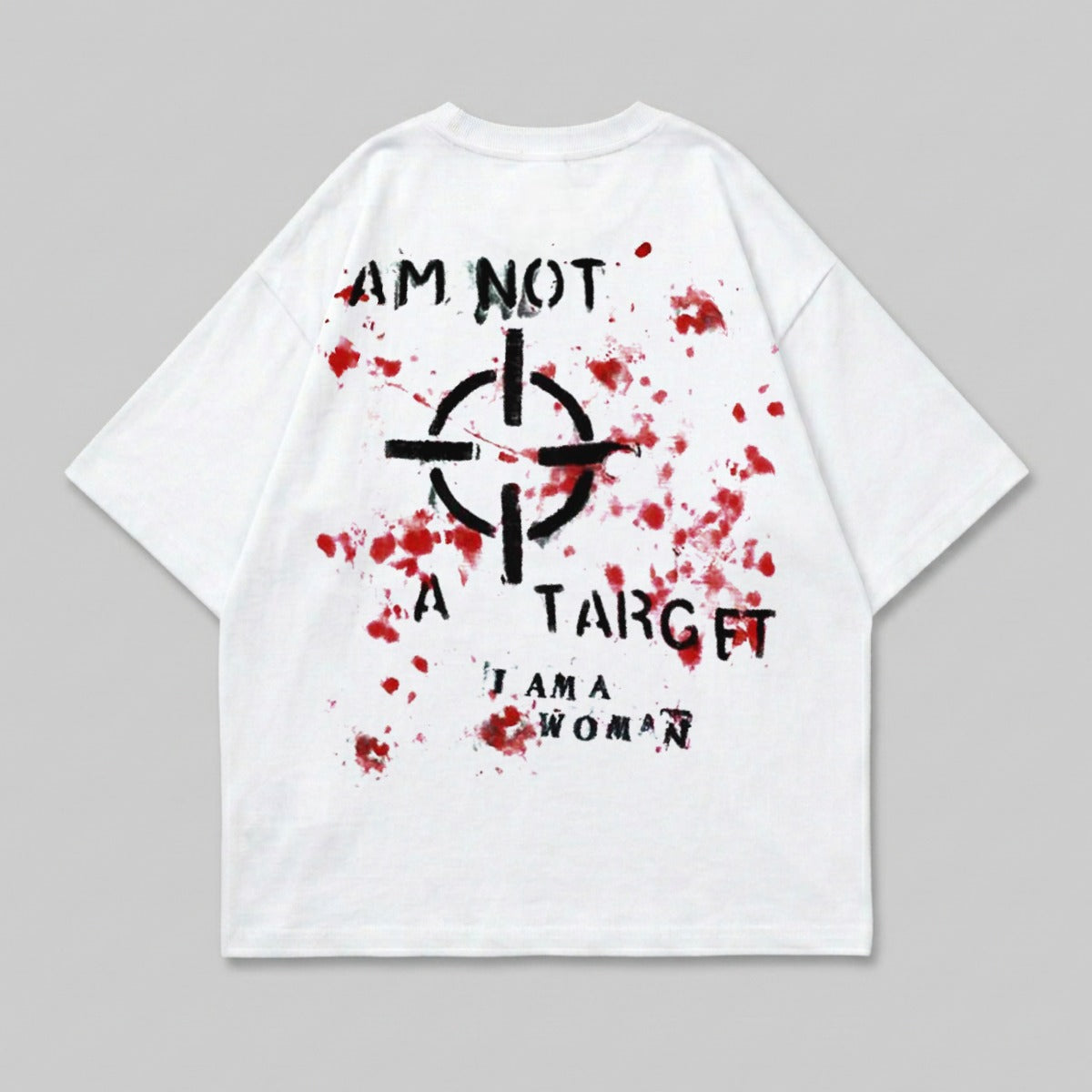 White t-shirt with black target graphic and "I AM NOT A TARGET I AM A WOMAN" text.
