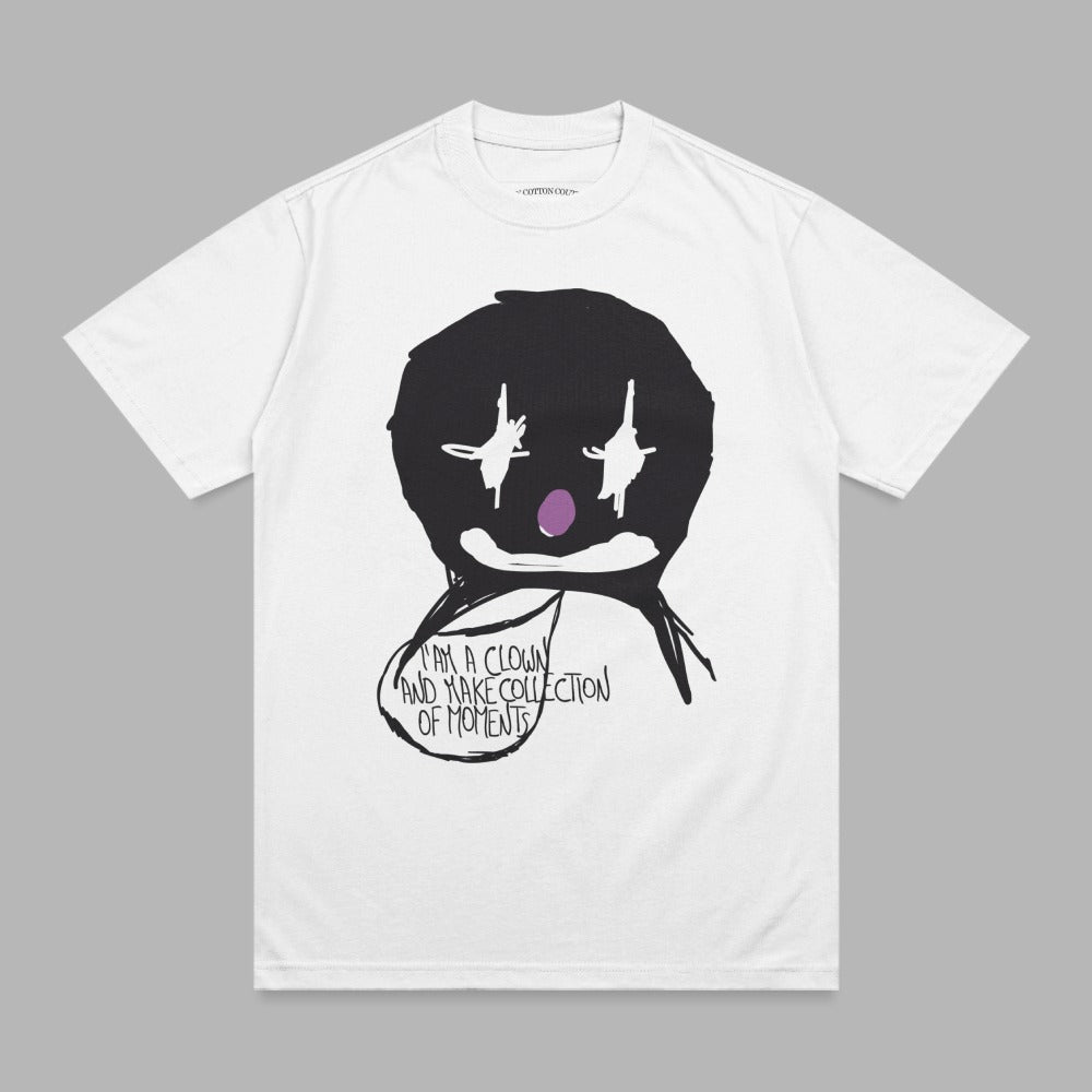 White t-shirt with a black clown face graphic and text bubble.