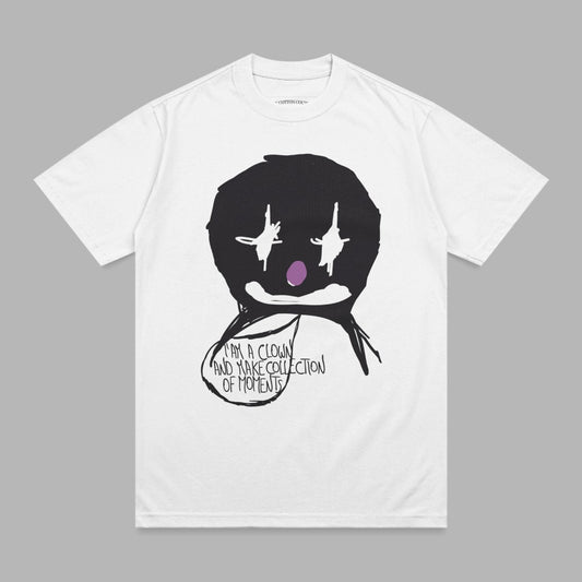 White t-shirt with a black clown face graphic and text bubble.