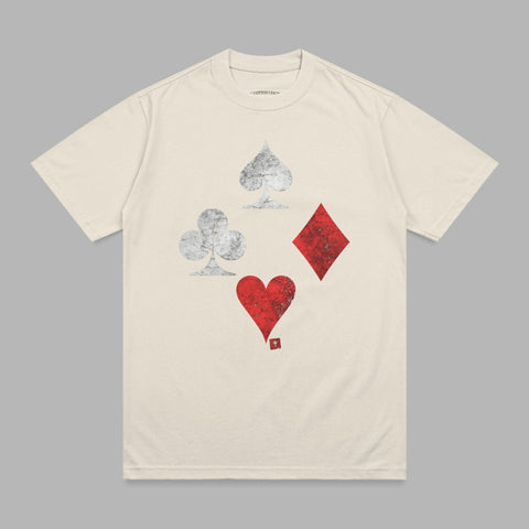 Cream t-shirt with distressed playing card suits: spades, clubs, diamonds, and hearts.