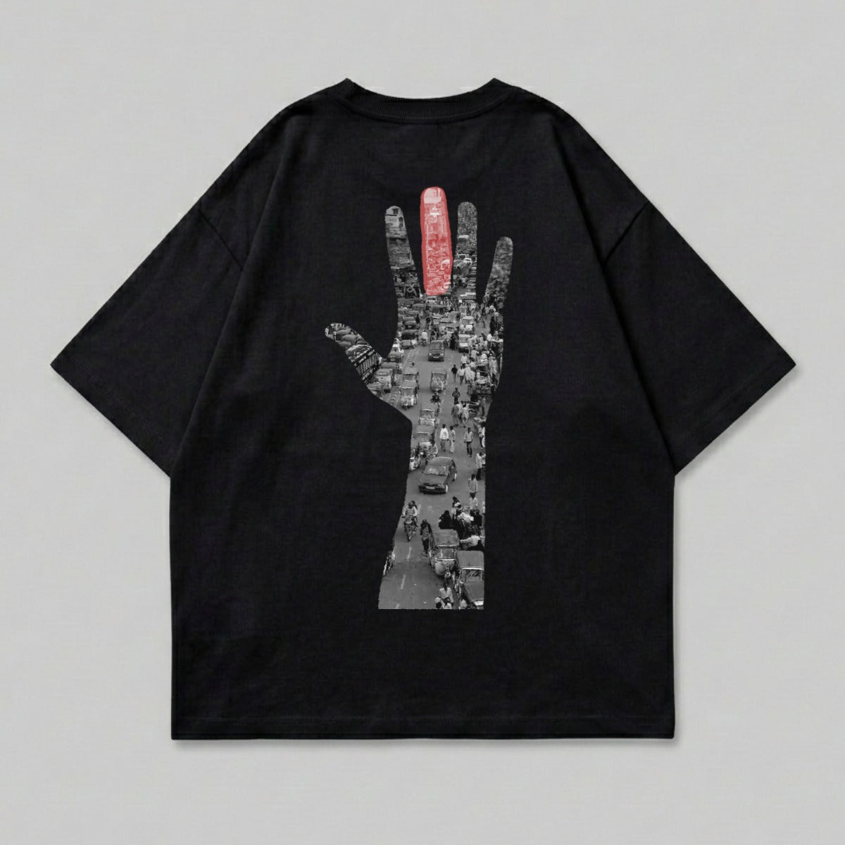 Black t-shirt with graphic of hand outline filled with busy street scene.