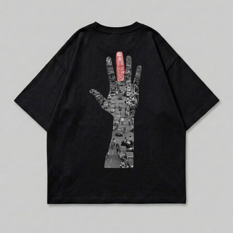 Black t-shirt with graphic of hand outline filled with busy street scene.