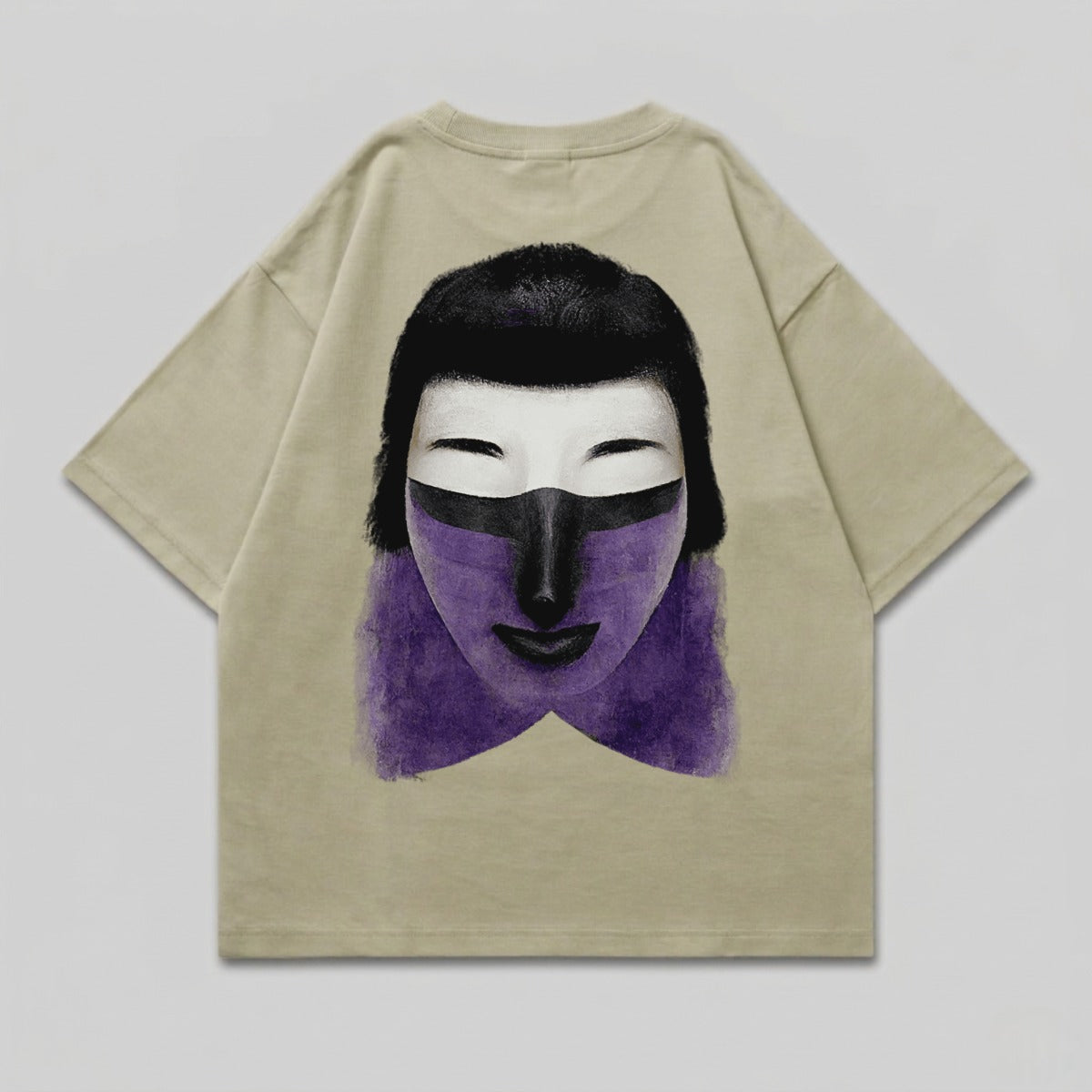 Light tan t-shirt with a graphic of a stylized face with purple and black markings.