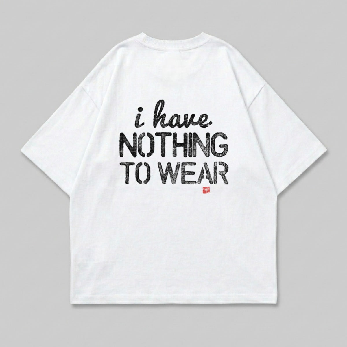 White t-shirt with black text "i have NOTHING TO WEAR" and a small red logo.