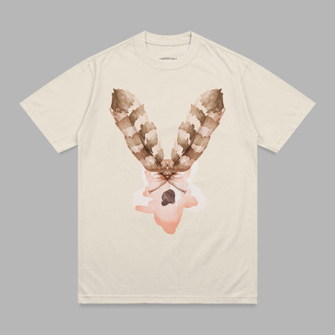 Cream t-shirt with brown feather and abstract pink design.