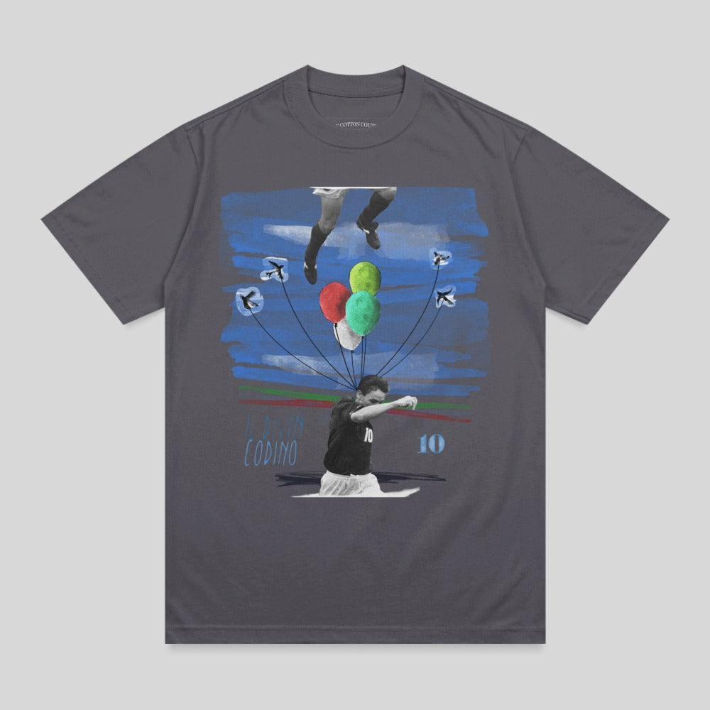 T-shirt graphic of a soccer player releasing balloons with blue streaks and birds.