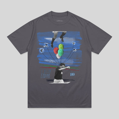 T-shirt graphic of a soccer player releasing balloons with blue streaks and birds.