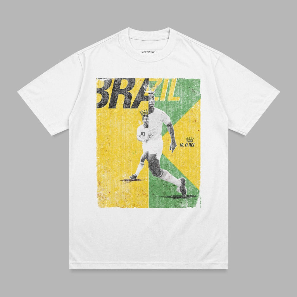 White t-shirt with vintage graphic of Brazilian soccer player Pelé running, "BRAZIL 10. O REI" text.