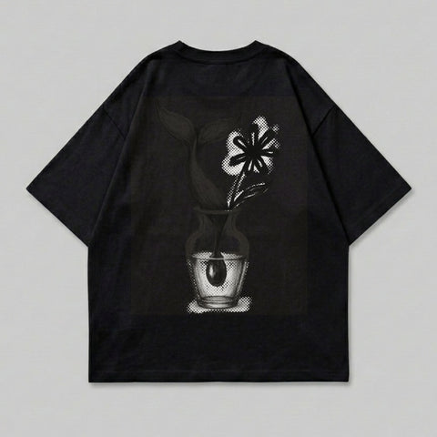 Black t-shirt with graphic of flower in vase on back.
