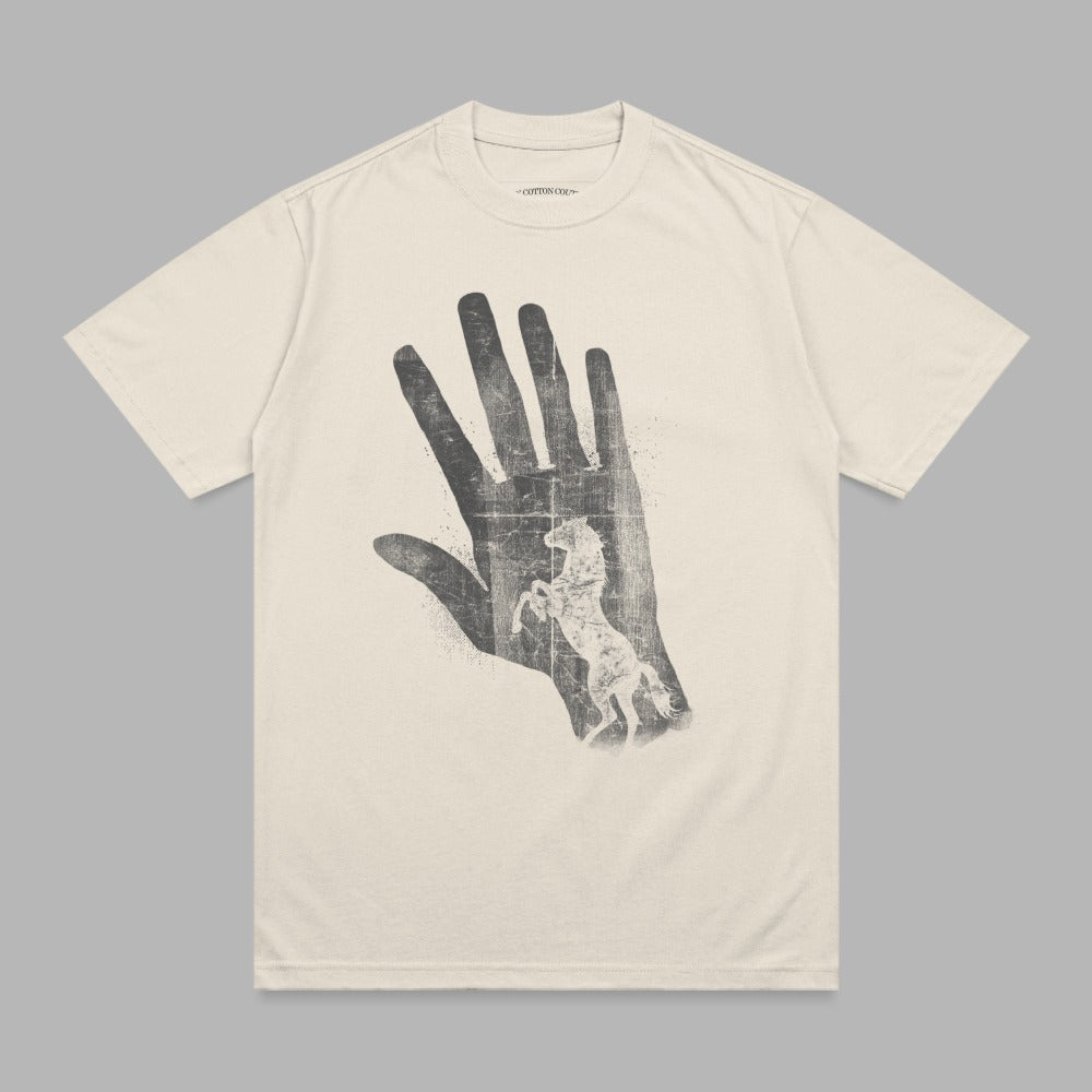 Cream t-shirt with distressed hand and horse graphic.
