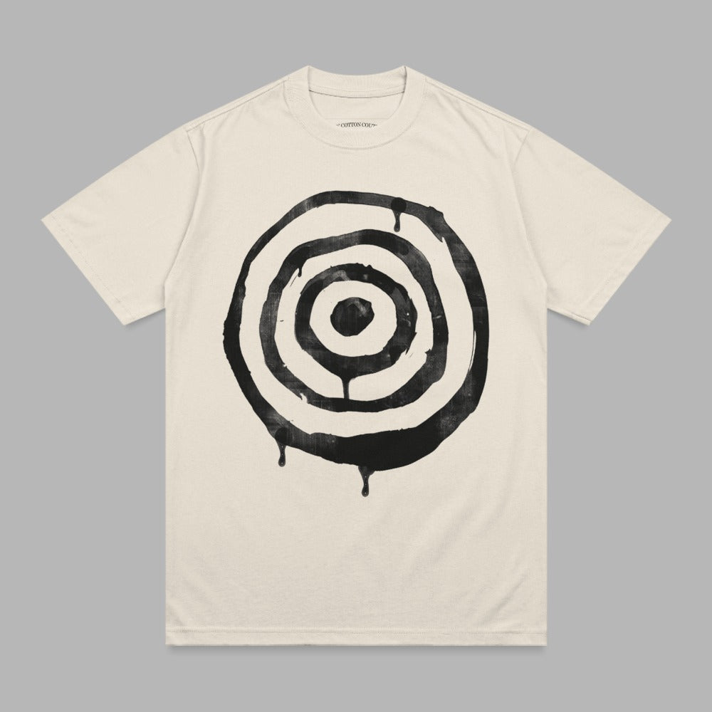 Cream t-shirt with black circular target graphic and dripping effect.