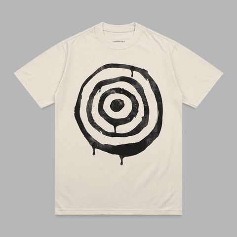 Cream t-shirt with black circular target graphic and dripping effect.