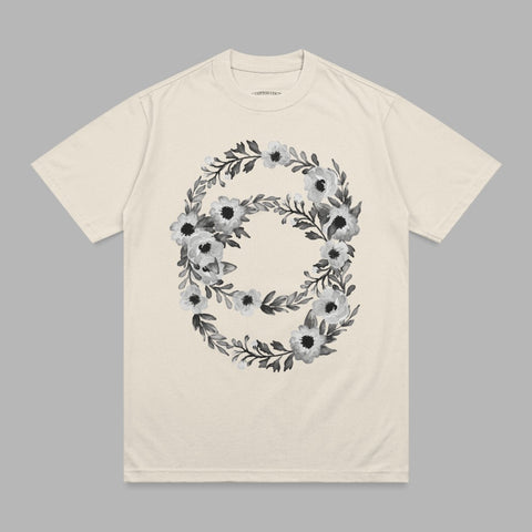 Cream t-shirt with a floral wreath design in black and white.