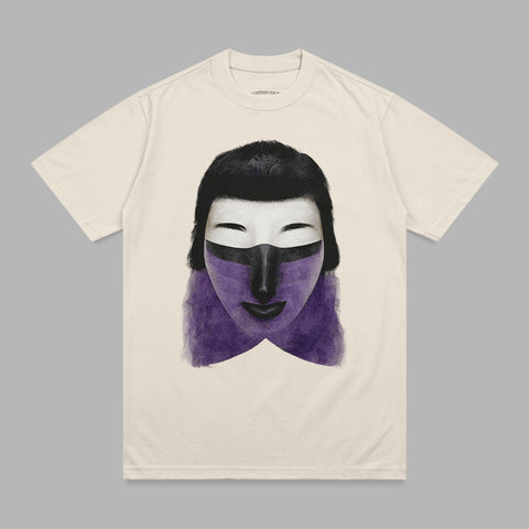 Cream t-shirt with abstract purple and black face mask graphic.