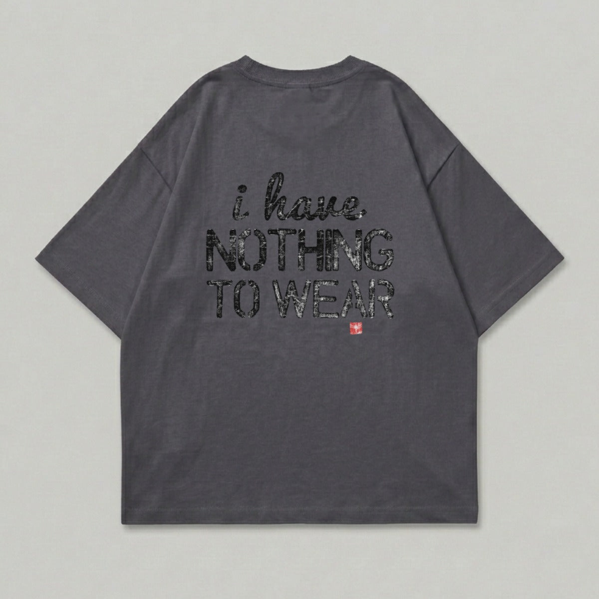 Dark grey t-shirt with black text reading "i have NOTHING TO WEAR" and a red square symbol.