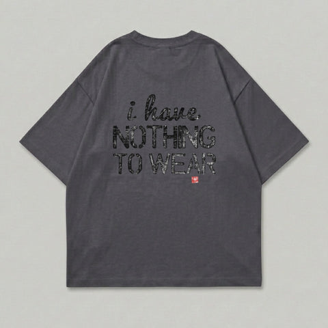 Dark grey t-shirt with black text reading "i have NOTHING TO WEAR" and a red square symbol.